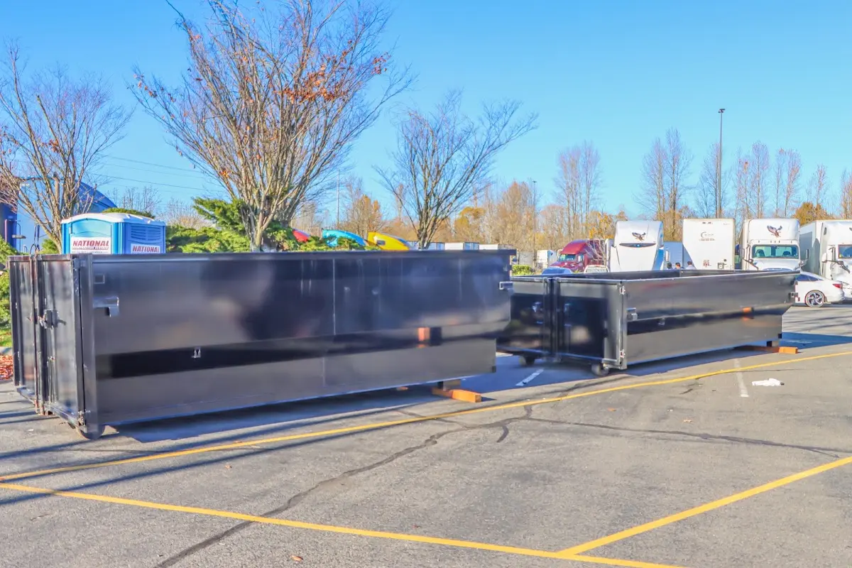 Professional dumpster rental service with roll-off container on residential driveway in Carlinville